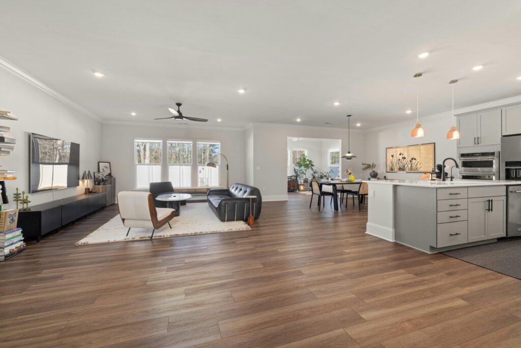 Bright and airy open-concept living space with kitchen, featuring modern furniture and elegant decor.